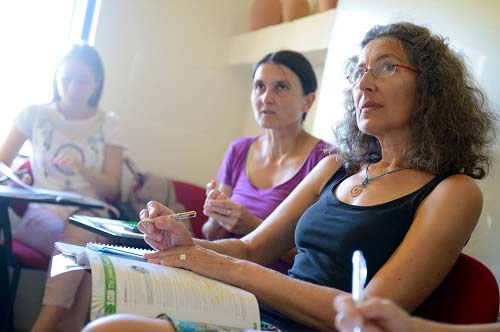 Three adults during their English courses