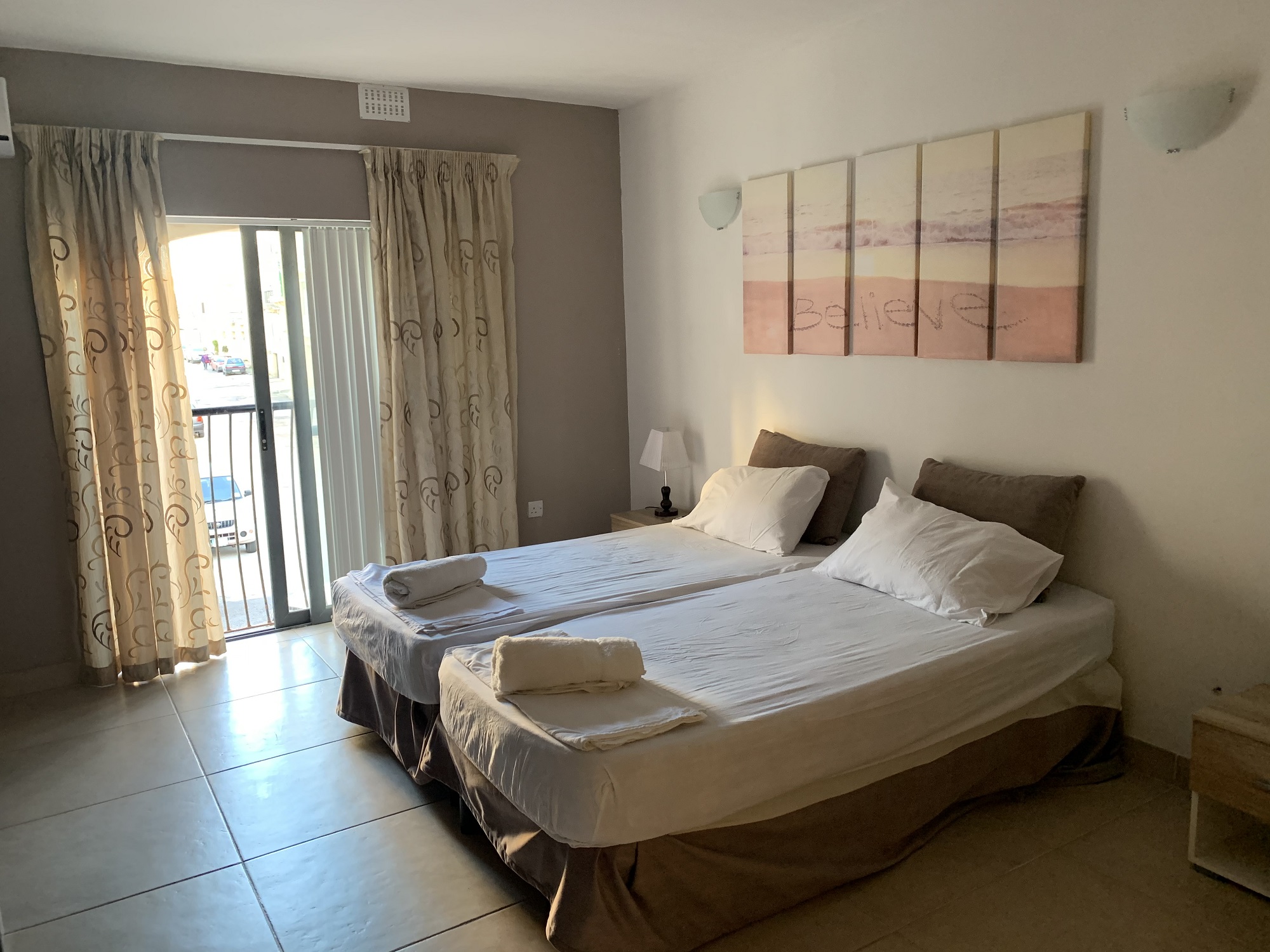 A twin room with a balcony at BELS Gozo student residence